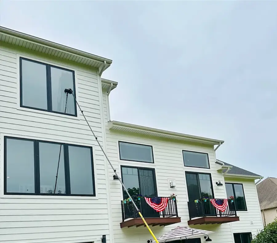 High and hard-to-reach two-story window cleaning with an extension pole