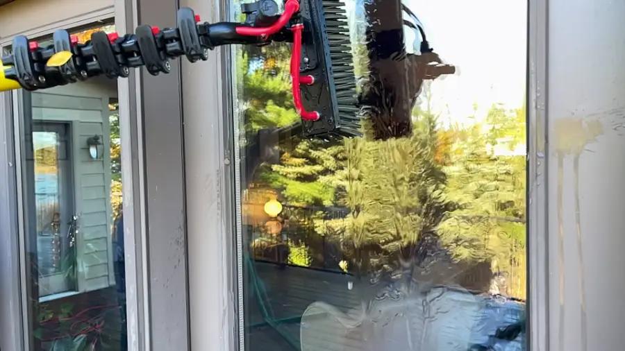 Professional water-fed brush head cleaning glass on a San Clemente home