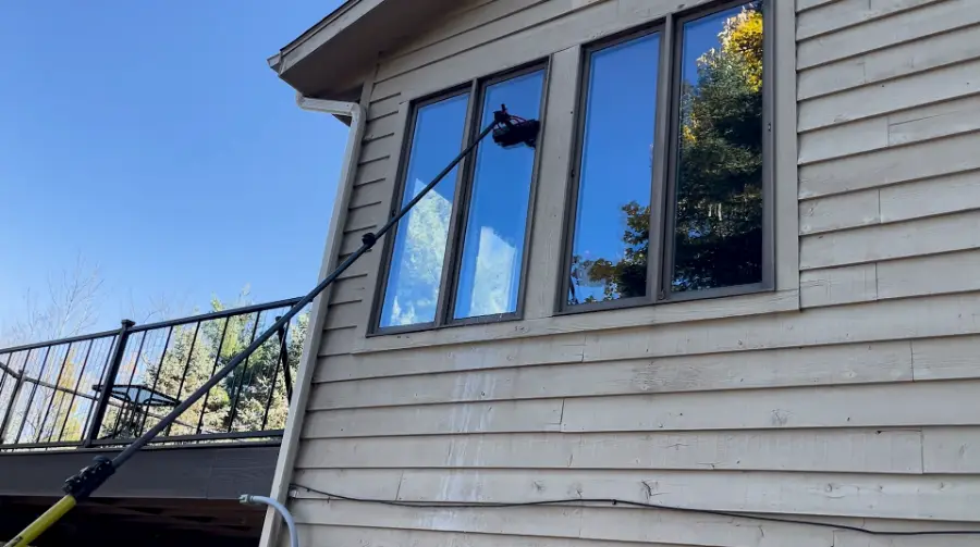 Professional window cleaning technician at work on a San Clemente home