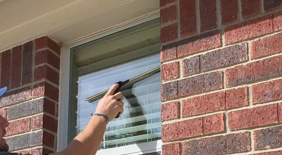 Exterior window squeegee cleaning technique in San Clemente, CA